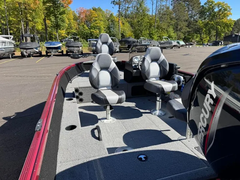 Slide: The Image of 2023 Alumacraft Competitor 165 CS boat with Mercury engine, parked outdoors. - 18