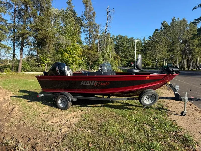 Slide: The Image of 2023 Alumacraft Competitor 165 CS boat on trailer outdoors. - 2