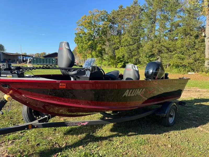 Slide: The Image of 2023 Alumacraft Competitor 165 CS boat on trailer outdoors. - 3