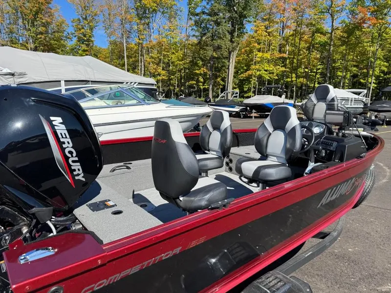 Slide: The Image of 2023 Alumacraft Competitor 165 CS boat with Mercury engine outdoors. - 4