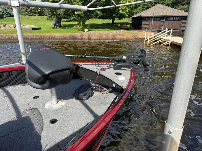 Slide: The Image of 2023 Alumacraft Competitor 165 CS with Minn Kota trolling motor by the lake. - 9