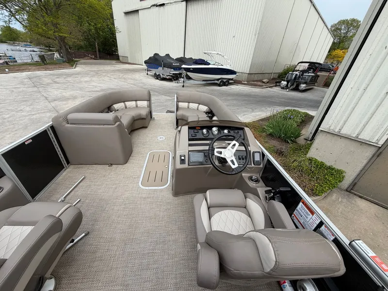 Slide: The Image of Interior of a 2019 Bennington 23SX pontoon boat with steering wheel and seating. - 11