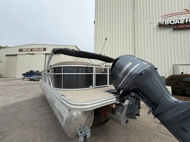 Slide: The Image of 2019 Bennington 23SX pontoon boat with Yamaha motor at boat house. - 3