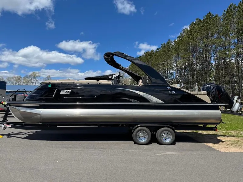 The Image of 2021 Bennington 25QXSBA ESP TRI pontoon boat on trailer. - 1