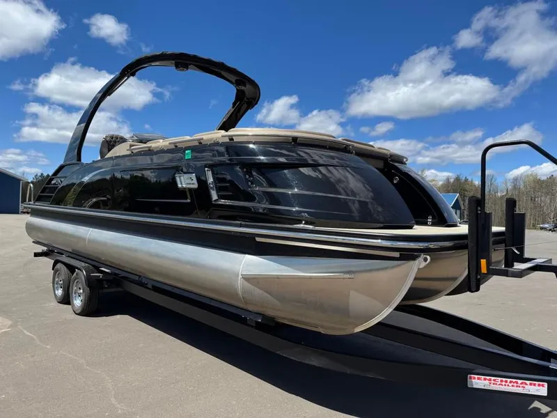 Slide: The Image of 2021 Bennington 25QXSBA ESP TRI on trailer, blue sky. - 3