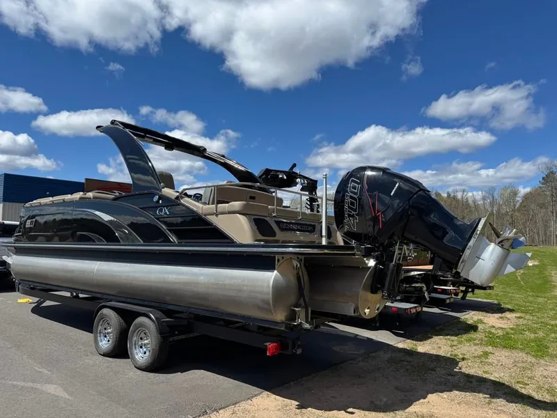 Slide: The Image of 2021 Bennington 25QXSBA ESP TRI on trailer, blue sky. - 6