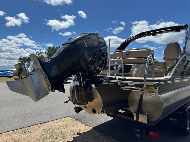 Slide: The Image of 2021 Bennington 25QXSBA ESP TRI with outboard motor, blue sky. - 8