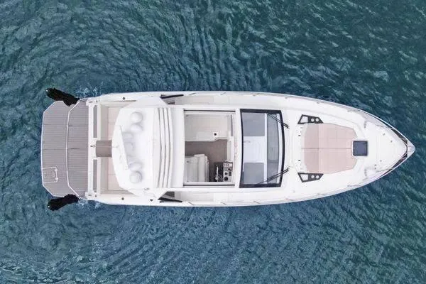 Slide: The Image of 2018 Cruisers Yachts 390 Express Coupe on water, aerial view showcasing sleek design. - 10