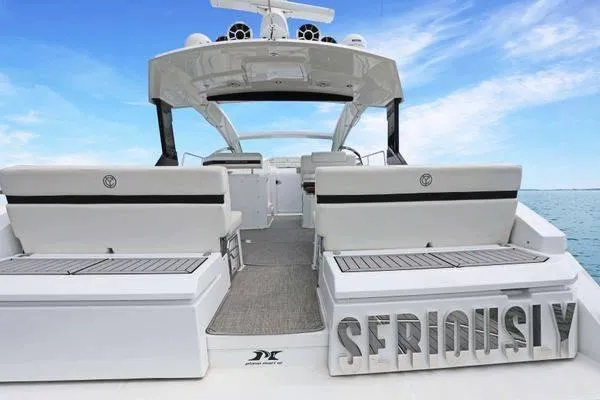 Slide: The Image of 2018 Cruisers Yachts 390 Express Coupe, luxury seating, open deck, ocean backdrop. - 12