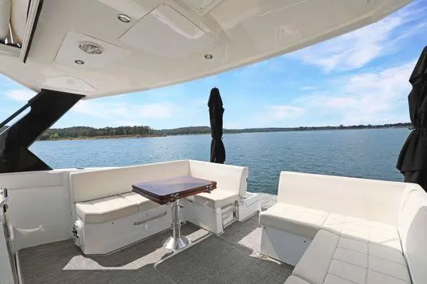 Slide: The Image of 2018 Cruisers Yachts 390 Express Coupe with spacious deck seating and scenic water view. - 20