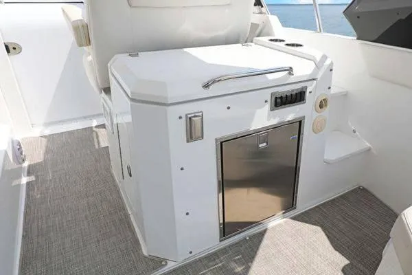 Slide: The Image of 2018 Cruisers Yachts 390 Express Coupe interior with compact kitchenette and ocean view. - 25