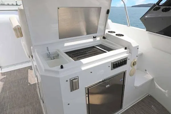 Slide: The Image of Outdoor kitchen on 2018 Cruisers Yachts 390 Express Coupe with grill and sink. - 26