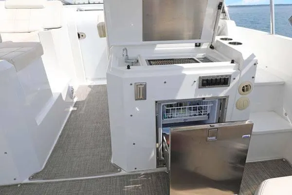 Slide: The Image of 2018 Cruisers Yachts 390 Express Coupe outdoor kitchen with grill and dishwasher. - 27
