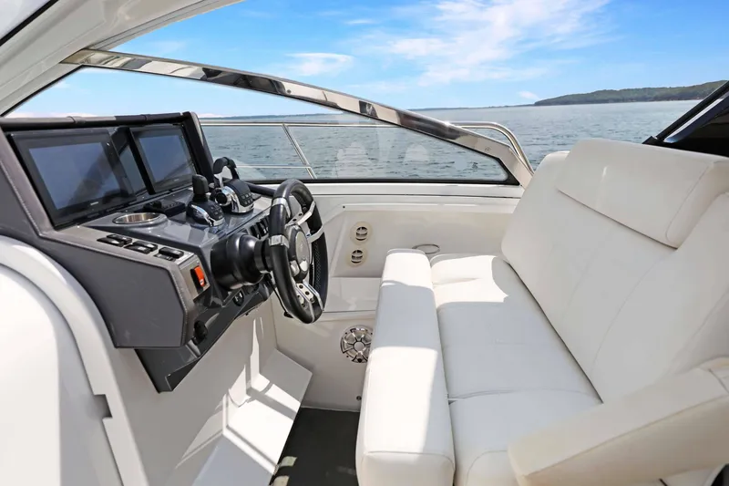 Slide: The Image of 2018 Cruisers Yachts 390 Express Coupe helm with white seating and ocean view. - 29