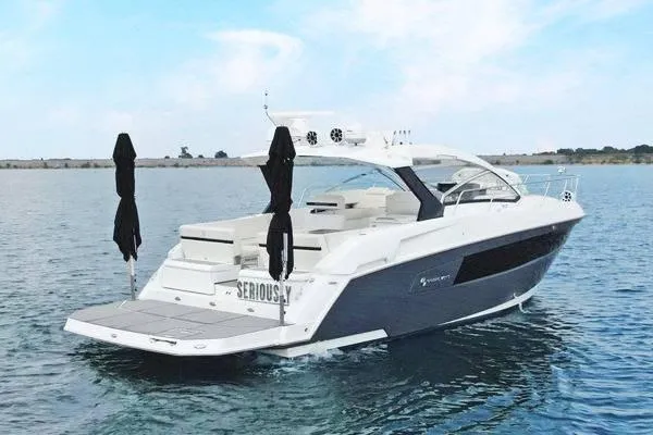 Slide: The Image of 2018 Cruisers Yachts 390 Express Coupe on calm water, showcasing sleek design and luxury features. - 3