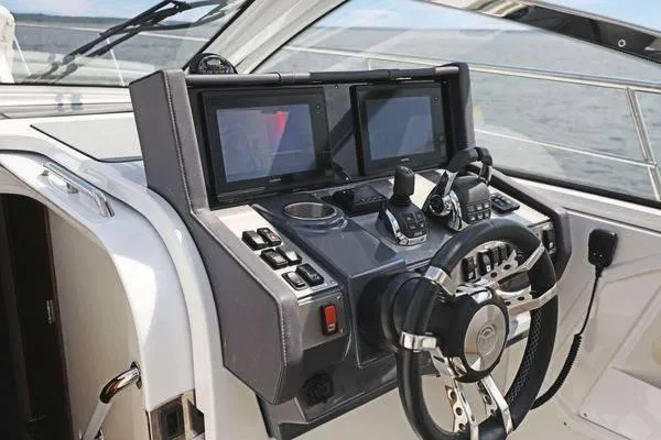 Slide: The Image of 2018 Cruisers Yachts 390 Express Coupe helm with dual screens and modern controls. - 30