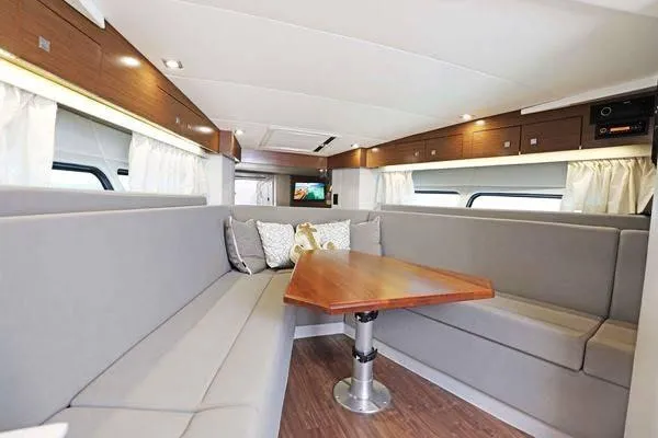 Slide: The Image of Luxurious interior of 2018 Cruisers Yachts 390 Express Coupe with elegant seating and wooden table. - 37