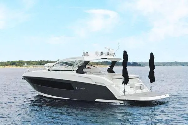 Slide: The Image of 2018 Cruisers Yachts 390 Express Coupe on calm water under a clear sky. - 4