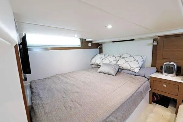 Slide: The Image of Luxurious cabin interior of 2018 Cruisers Yachts 390 Express Coupe with cozy bedding. - 41