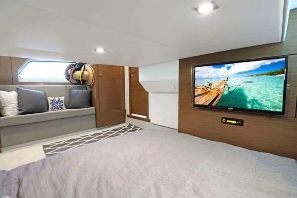 Slide: The Image of 2018 Cruisers Yachts 390 Express Coupe interior with cozy seating and wall-mounted TV. - 43