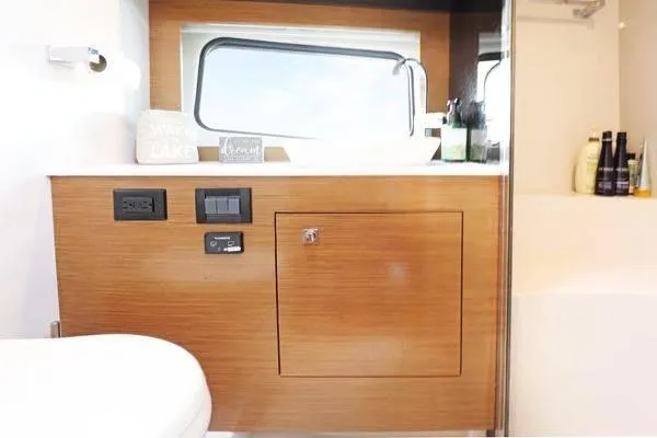 Slide: The Image of 2018 Cruisers Yachts 390 Express Coupe bathroom with wooden cabinetry and modern fixtures. - 44