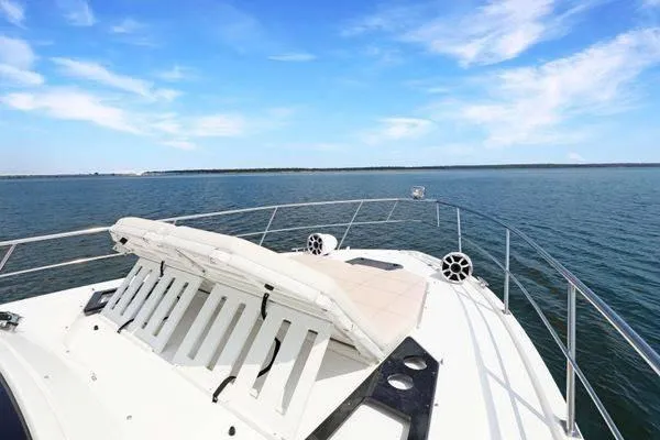 Slide: The Image of 2018 Cruisers Yachts 390 Express Coupe on serene water under a clear blue sky. - 47