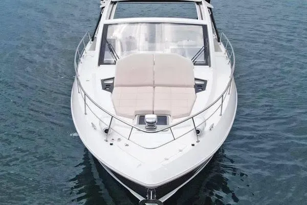 Slide: The Image of 2018 Cruisers Yachts 390 Express Coupe on water, showcasing sleek design and luxury features. - 6