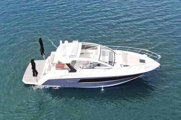Slide: The Image of 2018 Cruisers Yachts 390 Express Coupe on calm blue water. - 7
