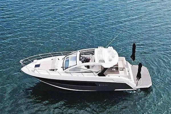 Slide: The Image of 2018 Cruisers Yachts 390 Express Coupe on clear blue water. - 9