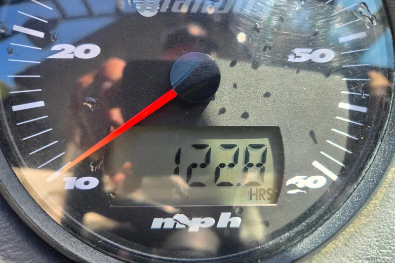 Slide: The Image of Close-up of a 2003 Malibu Sunscape 21 LSV speedometer showing 1220 hours. - 15