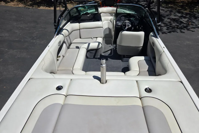 Slide: The Image of 2003 Malibu Sunscape 21 LSV boat interior with white seating and steering wheel. - 3