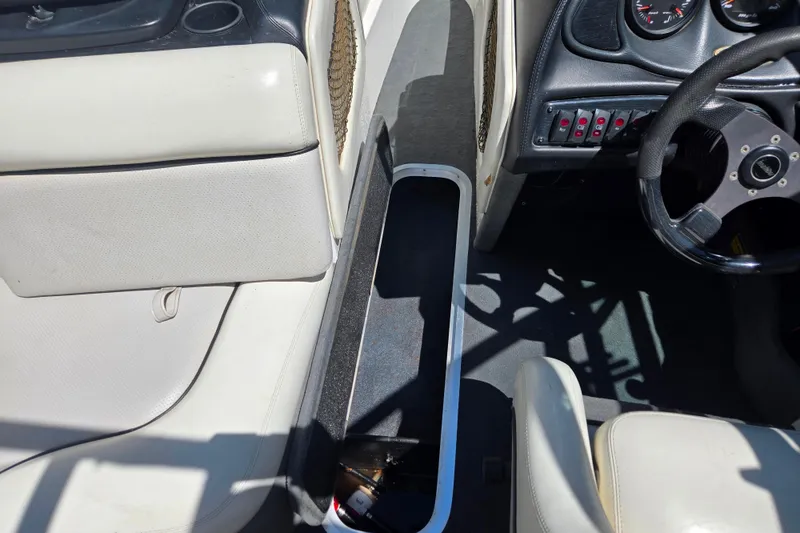 Slide: The Image of Interior of a 2003 Malibu Sunscape 21 LSV boat, featuring steering wheel and dashboard controls. - 4