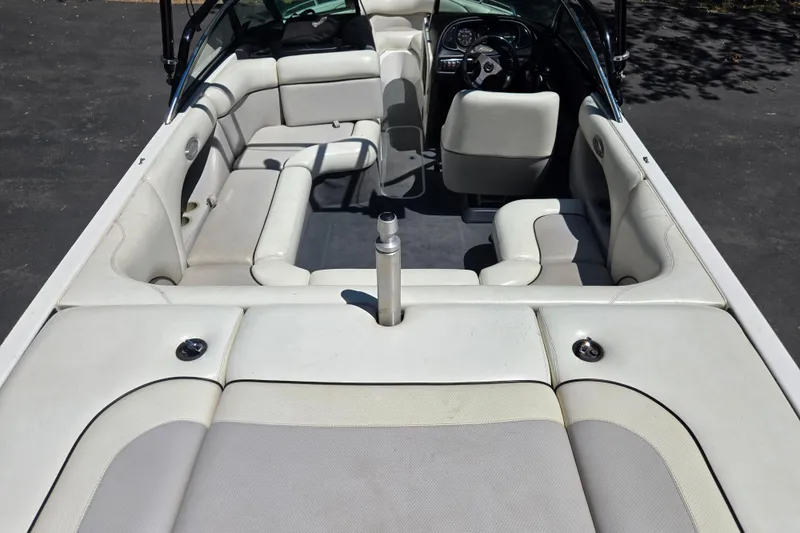 Slide: The Image of 2003 Malibu Sunscape 21 LSV boat interior with white seating and steering wheel. - 6