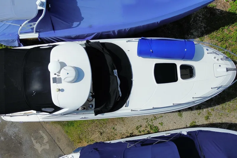 Slide: The Image of Overhead view of a 2003 Monterey 302 Cruiser boat with blue cover. - 10