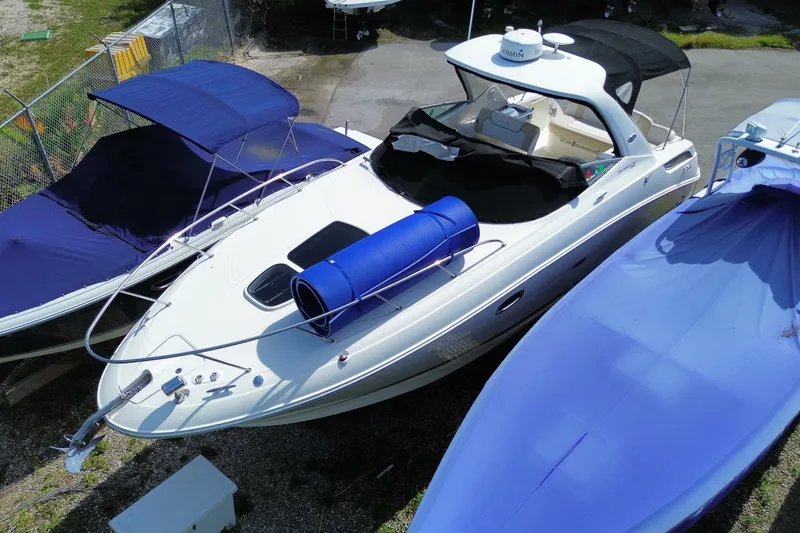 Slide: The Image of 2003 Monterey 302 Cruiser boat docked with blue covers and accessories. - 13