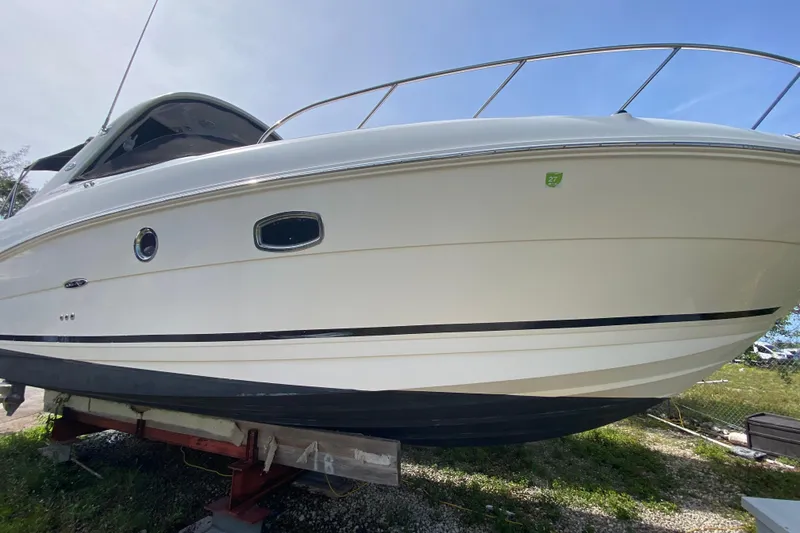 Slide: The Image of 2003 Monterey 302 Cruiser boat on dry dock, side view under clear sky. - 15