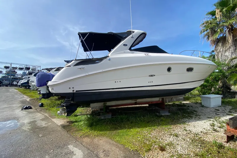 Slide: The Image of 2003 Monterey 302 Cruiser boat on dry dock, surrounded by greenery and clear skies. - 18