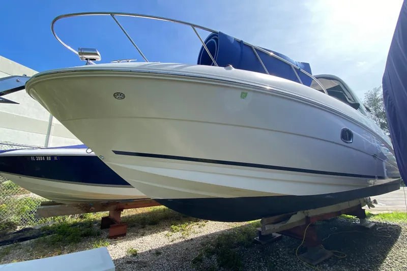 Slide: The Image of 2003 Monterey 302 Cruiser boat on dry dock under clear blue sky. - 19