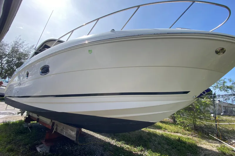 Slide: The Image of 2003 Monterey 302 Cruiser boat on land, showcasing sleek design and white hull. - 20