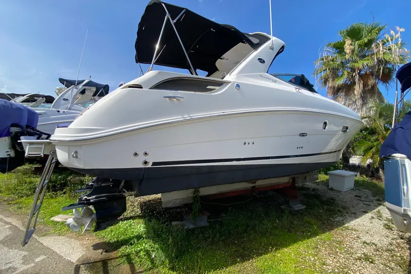 Slide: The Image of 2003 Monterey 302 Cruiser boat on land, with blue sky and palm trees. - 21