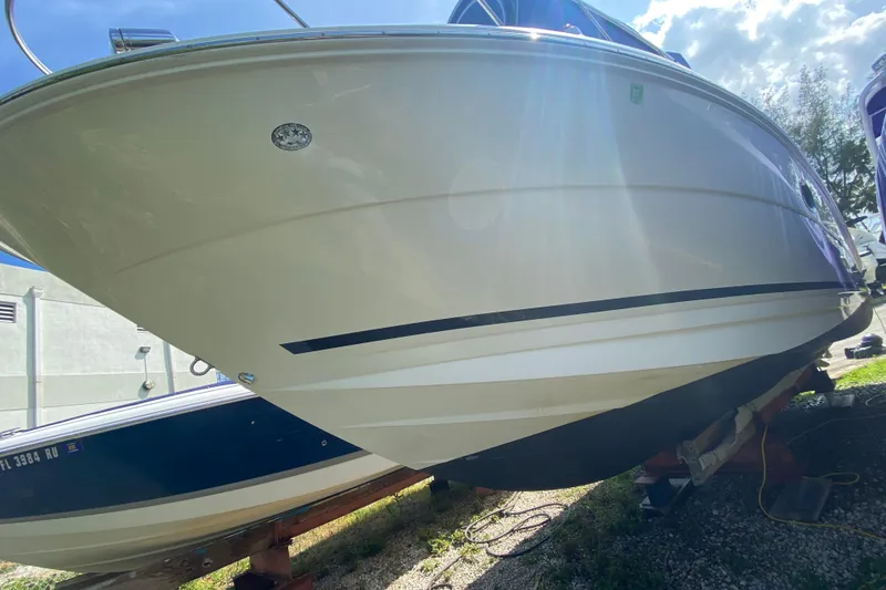Slide: The Image of 2003 Monterey 302 Cruiser boat on dry dock under bright sunlight. - 22