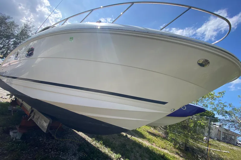 Slide: The Image of 2003 Monterey 302 Cruiser boat on land, under a clear blue sky. - 23