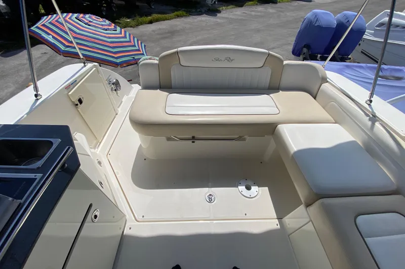 Slide: The Image of 2003 Monterey 302 Cruiser boat interior with seating and colorful umbrella. - 26