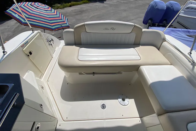 Slide: The Image of 2003 Monterey 302 Cruiser boat interior with seating and colorful umbrella. - 27