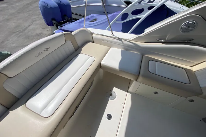 Slide: The Image of Interior seating of a 2003 Monterey 302 Cruiser boat, featuring beige and white upholstery. - 29