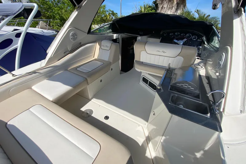 Slide: The Image of 2003 Monterey 302 Cruiser interior with seating, sink, and control panel in sunlight. - 30