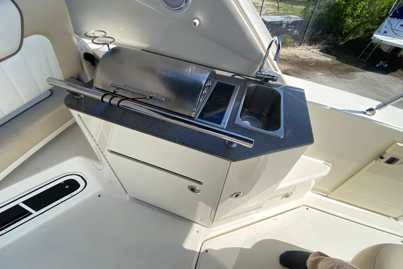 Slide: The Image of 2003 Monterey 302 Cruiser boat kitchenette with grill and sink. - 31