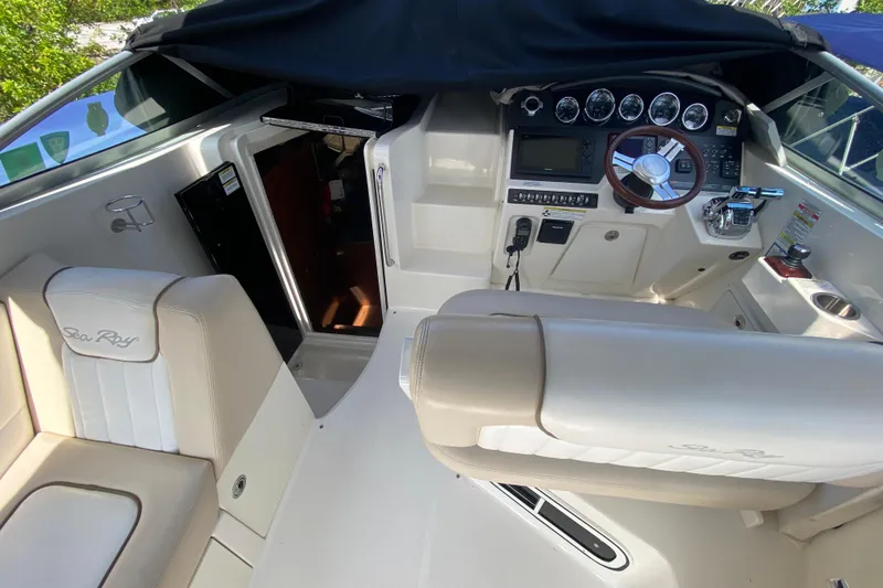 Slide: The Image of Interior view of a 2003 Monterey 302 Cruiser boat cockpit with steering and seating. - 35