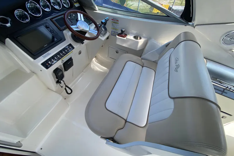 Slide: The Image of Interior of a 2003 Monterey 302 Cruiser boat with steering wheel and control panel. - 36
