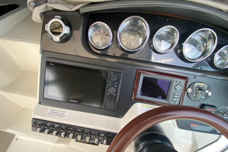 Slide: The Image of Dashboard of a 2003 Monterey 302 Cruiser with gauges and navigation equipment. - 39